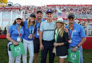 Justin Rose of Team Europe poses with family near the 18th hole green